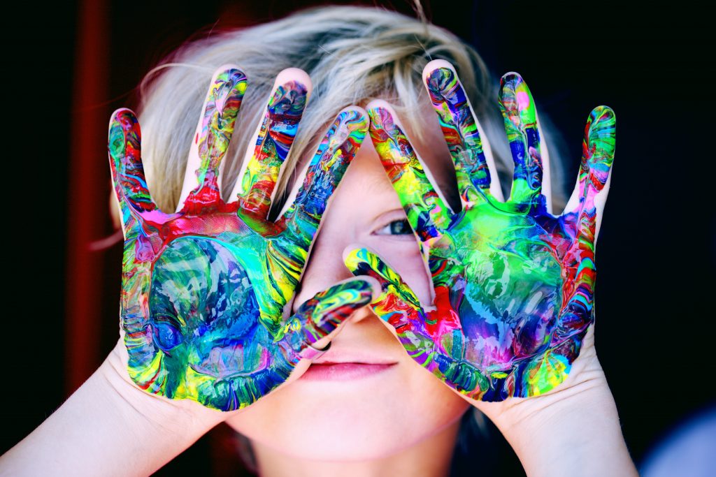 child with tie-dyed hands